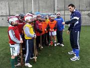 29 October 2008; Ulster Bank and Cork star Sean Og O hAilpin with the Raheny U12 hurling players who he put through their paces in Dublin today. The club won a coaching session with bank employee Sean Og as part of an Ulster Bank GAA promotion. The team braved the cold weather to get some tips from the Cork hurling legend. Raheny GAA Club, Dublin. Picture credit: Brian Lawless / SPORTSFILE