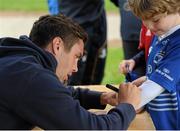 22 July 2015; Leinster rugby players Colm O'Shea and Gavin Thornbury visited the Bank of Ireland Summer Camp at Seapoint RFC to meet with young players. Pictured Colm O'Shea gives an autograph to one of the camp's participants. Seapoint RFC, Killiney, Co. Dublin. Picture credit: Sam Barnes / SPORTSFILE