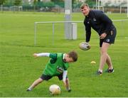 22 July 2015; Leinster rugby players Colm O'Shea and Gavin Thornbury visited the Bank of Ireland Summer Camp at Seapoint RFC to meet with young players. Pictured Gavin Thornbury sneakily attacks an unsuspecting camp participant during a game of dodge ball. Seapoint RFC, Killiney, Co. Dublin. Picture credit: Sam Barnes / SPORTSFILE