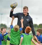 22 July 2015; Leinster rugby players Colm O'Shea and Gavin Thornbury visited the Bank of Ireland Summer Camp at Seapoint RFC to meet with young players. Pictured Gavin Thornbury tries to keep the ball from a group of camp participants. Seapoint RFC, Killiney, Co. Dublin. Picture credit: Sam Barnes / SPORTSFILE