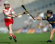 3 September 2000;  Elaine Burke of Cork in action against Claire Madden of Tipperary during the All-Ireland Senior Camogie Championship Final match between Tipperary and Cork at Croke Park in Dublin. Photo by Pat Murphy/Sportsfile