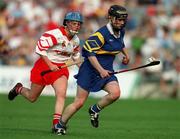 3 September 2000; Emer McDonnell of Tipperary in action against Vivienne Harris of Cork during the All-Ireland Senior Camogie Championship Final match between Tipperary and Cork at Croke Park in Dublin. Photo by Pat Murphy/Sportsfile
