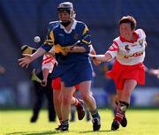 3 September 2000; Emer McDonnell of Tipperary in action against Mags Finn of Cork during the All-Ireland Senior Camogie Championship Final match between Tipperary and Cork at Croke Park in Dublin. Photo by Pat Murphy/Sportsfile