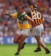 10 September 2000; Johnny Dooley of Offaly  is tackled by Canice Brennan of Kilkenny during the All-Ireland Senior Hurling Championship Final match between Kilkenny and Offaly at Croke Park in Dublin. Photo by Ray McManus/Sportsfile