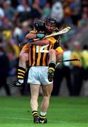 10 September 2000; Kilkenny's DJ Carey celebrates with team mate Denis Byrne after the All-Ireland Senior Hurling Championship Final match between Kilkenny and Offaly at Croke Park in Dublin. Photo by Ray McManus/Sportsfile