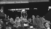 28 September 1975; Pat Spillane lifts the Sam Maguire after Team Captain Mickey 'Ned' O'Sullivan had been injured during the All-Ireland Football Final between Kerry and Dublin Photo by Connolly Collection/Sportsfile