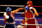 18 September 2000;  Turkey's Firat Karagollu, left, lands a left to the jaw of Ireland's Michael Roche during his victory over Roche in the Men's 71kg First Round. Sydney Exhibition Hall 3, Darling Harbour, Sydney, Australia. Photo by Brendan Moran/Sportsfile