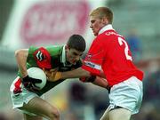 24 September 2000:  Tony Geraghty of Mayo is tackled by Noel O'Donovan of Cork during the All Ireland Minor Football Championship Final match between Cork and Mayo at Croke Park in Dublin. Photo by Ray McManus/Sportsfile
