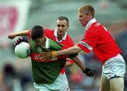 24 September 2000:  Tony Geraghty of Mayo is tackled by Noel O'Donovan, right, and Paul McCarthy of Cork during the All Ireland Minor Football Championship Final match between Cork and Mayo at Croke Park in Dublin. Photo by Ray McManus/Sportsfile