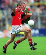 24 September 2000: James Masters of Cork in action against Dermot Geraghty of Mayo during the All Ireland Minor Football Championship Final match between Cork and Mayo at Croke Park in Dublin. Photo by Ray McManus/Sportsfile