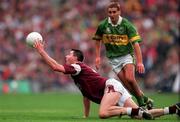 24 September 2000; Sean O'Domhnaill of Galway passes the ball away ahead of Maurice Fitzgerald of Kerry during the Bank of Ireland All-Ireland Football Championship Final Replay between Galway and Kerry at Croke Park in Dublin. Photo by Ray McManus/Sportsfile