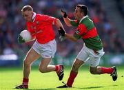 24 September 2000: David Burns of Cork is tackled by Ronan Walshe of Mayo during the All Ireland Minor Football Championship Final match between Cork and Mayo at Croke Park in Dublin. Photo by Ray McManus/Sportsfile