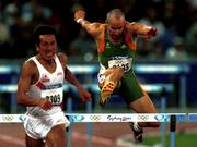 23 September 2000; Ireland's Tom McGuirk jumps the final hurdle behind japan's Hideaki Kawamura in the heats of the Men's 400m Hurdles Stadium Australia, Sydney Olympic Park. Homebush Bay, Sydney, Australia. Photo by Brendan Moran/Sportsfile