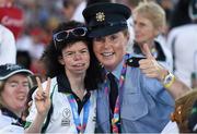 24 July 2015; Team Ireland’s Ashleigh O’Hagan, a member of Lisnagry Special Olympics Club, from Limerick City, with Garda sargent Michaela Moloney, from Henry Stree station, Limerick, and a member of the Law Enforcement Torch Run Team during the opening ceremony of the Special Olympics World Summer Games. LA Memorial Coliseum, Los Angeles, United States. Picture credit: Ray McManus / SPORTSFILE