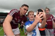 26 July 2015; Michael Morrissey, age 10, from Fourmilewater, Waterford, has a picture taken with Jason Flynn, Galway. GAA Hurling All-Ireland Senior Championship, Quarter-Final, Galway v Cork. Semple Stadium, Thurles, Co. Tipperary. Picture credit: Stephen McCarthy / SPORTSFILE