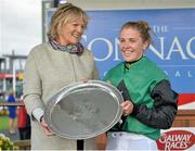 27 July 2015; Jockey Kate Harrington lifts the trophy with trainer Jessica Harrington after winning The Connacht Hotel (Q.R.) Handicap on Modem. Galway Racing Festival. Ballybrit, Galway. Picture credit: Cody Glenn / SPORTSFILE