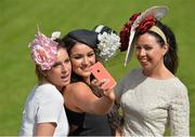 28 July 2015; Racegoers, from left, Sophia Small, Laura Fox and Denise Pia, all of Galway City, snap a pre-race selfie. Galway Racing Festival, Ballybrit, Galway. Picture credit: Cody Glenn / SPORTSFILE