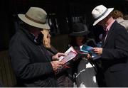 28 July 2015; Punters study their race cards early in the day. Galway Racing Festival, Ballybrit, Galway. Picture credit: Cody Glenn / SPORTSFILE