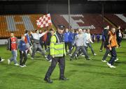 15 November 2008; A member of the Garda Síochána with supporters on the pitch at the end of the game between Shelbourne and Limerick 37. eircom League First Division, Shelbourne v Limerick 37, Tolka Park, Dublin. Picture credit: David Maher / SPORTSFILE