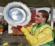 29 July 2015; Jonathan Burke raises thetote.com Galway Plate 2015 after riding Shanahan's Turn to victory in the thetote.com Galway Plate. Galway Racing Festival, Ballybrit, Galway. Picture credit: Cody Glenn / SPORTSFILE
