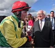 29 July 2015; Jockey Jonathan Burke is congratulated by The President of Ireland Michael D. Higgins after winning the thetote.com Galway Plate. Galway Racing Festival, Ballybrit, Galway. Picture credit: Cody Glenn / SPORTSFILE