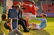 29 July 2015; Chris Forrester, St Patrick's Athletic, is sent crashing into the dug outs by Sam Tattum, Manchester City Elite Development Squad. Pre-Season Friendly, St Patrick'ss Athletic v Manchester City Elite Development Squad. Richmond Park, Dublin. Picture credit: Sam Barnes / SPORTSFILE