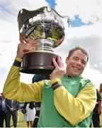 30 July 2015; Denis O'Regan lifts the trophy after riding Quick Jack to victory in the Guinness Galway Hurdle Handicap. Galway Racing Festival, Ballybrit, Galway. Picture credit: Cody Glenn / SPORTSFILE