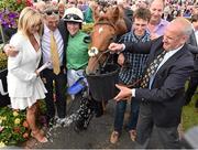 30 July 2015; Trainer Tony Martin gives a drink of water to Quick Jack after winning the Guinness Galway Hurdle Handicap as owners Debbie and John Breslin and jockey Denis O'Regan look on. Galway Racing Festival, Ballybrit, Galway. Picture credit: Cody Glenn / SPORTSFILE
