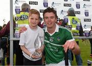 30 July 2015; Shane Cross, aged 10, from St. Patrick's GAA club, Limerick, presents the Bord Gáis Energy Man of the Match award to Ronan Lynch, Limerick. Bord Gáis Energy Munster GAA Hurling U21 Championship Final, Clare v Limerick, Cusack Park, Ennis, Co. Clare. Picture credit: Diarmuid Greene / SPORTSFILE