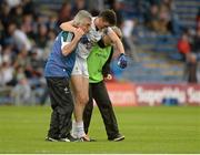 25 July 2015; Mick O'Grady, Kildare, is helped off the field by medics after picking up an injury. GAA Football All-Ireland Senior Championship, Round 4A, Kildare v Cork. Semple Stadium, Thurles, Co. Tipperary. Picture credit: Piaras Ó Mídheach / SPORTSFILE