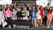 30 July 2015; Jockey Denis O'Regan holds the trophy with winning connections after winning the Guinness Galway Hurdle Handicap on Quick Jack. Galway Racing Festival, Ballybrit, Galway. Picture credit: Cody Glenn / SPORTSFILE