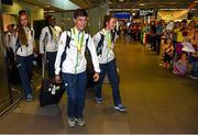 3 August 2015; Ireland gold medallists Kevin McGrath, age 16, Bohermeen A.C., Navan, gold medallist in the 1500 meters, and Ciara Neville, age 15, Emerald A.C., Limerick, lead teammates into the terminal at the Irish team's return from the European Youth Olympics. Dublin Airport, Dublin. Picture credit: Cody Glenn / SPORTSFILE