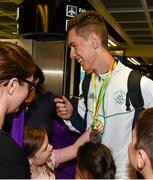 3 August 2015; Ireland's Ryan Carthy Walsh, age 16, Adamstown, A.C., is welcomed home by family and friends after winning a silver medal in the high jump, at the Irish team's return from the European Youth Olympics. Dublin Airport, Dublin. Picture credit: Cody Glenn / SPORTSFILE