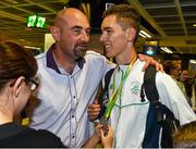 3 August 2015; Ireland silver medallist Ryan Carthy Walsh, age 16, Adamstown A.C., Wexford, high jump, is welcomed home by his father Nicky at the Irish team's return from the European Youth Olympics. Dublin Airport, Dublin. Picture credit: Cody Glenn / SPORTSFILE