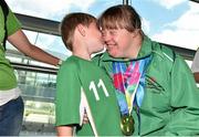 4 August 2015; Team Ireland's Amy Quinn, from Bray, Co. Wicklow, is greeted with a kiss on the cheek from nephew Éanna Quinn, age 8, after winning medals in badminton during their homecoming. Team Ireland returns from the Special Olympics World Summer Games. Terminal 2, Dublin Airport. Picture credit: Cody Glenn / SPORTSFILE