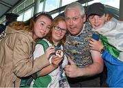 4 August 2015; Team Ireland's Nicola Higgins, from Kilmore West, Co. Dublin, proudly displays her bronze medal for kayaking, as she is greeted by her brother Thomas, niece Saoirse and nephew Darragh Higgins, during their homecoming. Team Ireland returns from the Special Olympics World Summer Games. Terminal 2, Dublin Airport. Picture credit: Cody Glenn / SPORTSFILE