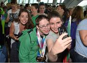 4 August 2015; Team Ireland's Liam Foley, from Killyon, Co. Meath, a badminton player, is greeted by his sisters Cara, right, and Niamh during their homecoming. Team Ireland returns from the Special Olympics World Summer Games. Terminal 2, Dublin Airport. Picture credit: Cody Glenn / SPORTSFILE