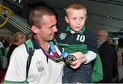 4 August 2015; Team Ireland's Leo O'Brien, from Rathdrum, Co. Wicklow, shows his silver medal for golf to his nephew Cathal Hayes, age 5, during their homecoming. Team Ireland returns from the Special Olympics World Summer Games. Terminal 2, Dublin Airport. Picture credit: Cody Glenn / SPORTSFILE
