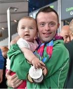 4 August 2015; Team Ireland's Paul Keane, from Ferns, Co. Wexford, reunites with his niece Mila Keane, age 6 months, after earning five medals: a gold, three silvers and a bronze plus two ribbons in gymnastics at Dublin Airport during their homecoming. Team Ireland returns from the Special Olympics World Summer Games. Terminal 2, Dublin Airport. Picture credit: Cody Glenn / SPORTSFILE