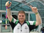 4 August 2015; Team Ireland's Robert Byrne, from Kildare Town, displays his bronze medal he won in football at Dublin Airport during their homecoming. Team Ireland returns from the Special Olympics World Summer Games. Terminal 2, Dublin Airport. Picture credit: Cody Glenn / SPORTSFILE