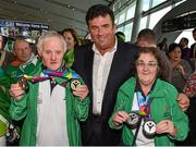 4 August 2015; Team Ireland gold medallists in Bocce Peter Malynn, left, a member of St Hilda’s Work Therapy Unit, from Mullingar, Co. Westmeath, and Anne Hoey, right, a member of Drogheda Special Olympics Club, from Drogheda, Co Louth, are greeted by RTE presenter Des Cahill at Dublin Airport during their homecoming. Team Ireland returns from the Special Olympics World Summer Games. Terminal 2, Dublin Airport. Picture credit: Cody Glenn / SPORTSFILE