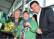 4 August 2015; Team Ireland's Amy Quinn, centre, from Bray, Co. Wicklow, is greeted after winning medals in badminton by Breda Connolly, president of Badminton Ireland, and RTE presenter Des Cahill at Dublin Airport during their homecoming. Team Ireland returns from the Special Olympics World Summer Games. Terminal 2, Dublin Airport. Picture credit: Cody Glenn / SPORTSFILE
