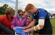 4 August 2015; Leinster's Tom Denton signs autographs for supporters following squad training. Leinster Rugby Squad Training. Edenderry, Co. Offaly. Picture credit: Eoin Noonan / SPORTSFILE