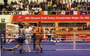29 November 2008; The referee stops the fight between Katie Taylor, Ireland, Blue, and Cheng Dong, China, during their 60kg bout, which Katie Taylor subsequently won by 13 points to 2. AIBA Women's World Boxing Championships - Final. Ningbo City, China. Picture credit: SPORTSFILE / Courtesy of AIBA