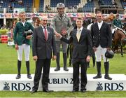 6 August 2015; Matt Dempsey, RDS President, front left, and Michael Rogers, front right, CityJet Leisure Marketing Executive, present the top three finishers, first-place Emanuele Guadiano, Italy, centre, who rode Cocoshynsky, second-place Bertram Allen, Ireland, left, who rode Quiet Easy 4, and third-place Cian O'Connor, Ireland, right, who rode Coco II with ribbons after the Serpentine Speed Stakes sponsored by CityJet  during the Discover Ireland Dublin Horse Show 2015. RDS, Ballsbridge, Dublin. Picture credit: Cody Glenn / SPORTSFILE