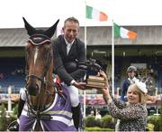 6 August 2015; Dermott Lennon, Ireland, accepts The Paul Darragh Perpetual Challenge Trophy from Jane Darragh, widow of the late Irish equestrian Paul Darragh, who competed in show jumping, after winning The Speed Derby sponsored by The Talbot Collection on Vampire during the Discover Ireland Dublin Horse Show 2015. RDS, Ballsbridge, Dublin. Picture credit: Cody Glenn / SPORTSFILE