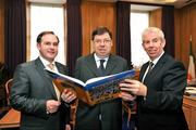 2 December 2008; Sportsfile photographer Ray McManus, right, and Alan Gilson, Commercial Director, Carroll Cusine, present a copy of A Season of Sundays 2008 to An Taoiseach Brian Cowen T.D. The 12th edition of the book is now available at all good book shops at €34:95. Government Buildings, Leinster House, Dublin. Picture credit: David Maher  / SPORTSFILE