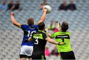 8 August 2015; Brian Crowley, Kerry, fists the ball ahead of Brendan Moran, left, and Blake Forkan, Mayo. GAA Football All-Ireland Junior Championship Final. Kerry v Mayo, Croke Park, Dublin. Picture credit: Stephen McCarthy / SPORTSFILE