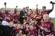 16 December 2008; Former Dublin footballer Barney Rock presents the cup to players of Scoil Mhaelruáin. Scoil Mhaelruáin, Old Bawn v Sacred Heart N.S., Corn Chumann na nGael Final, Allianz Cumann na mBunscoil football finals, Croke Park Dublin. Picture credit: David Maher / SPORTSFILE