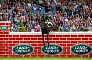 8 August 2015; Daniel Coyle, competing on Fanadwest Rebel, clearing the wall during the Land Rover Puissancein, during the Discover Ireland Dublin Horse Show 2015. RDS, Ballsbridge, Dublin. Picture credit: Matt Browne / SPORTSFILE